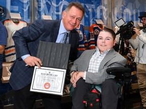 Edmonton Oilers general manager Ken Holland poses at Rogers Place with Owen McGonigal, a former Stollery Children's Hospital patient who now lives in London. Ont. McGonigal was signed as Oilers GM For A Day on Thursday, October 17, 2019, an opportunity organized by the Make-A-Wish Foundation.
