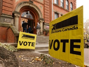 Voters are seen outside of a polling station at McKay Avenue School Archives and Museum at 10425 99 Avenue during the 2019 Federal Election in Edmonton, on Monday, Oct. 21, 2019. Photo by Ian Kucerak/Postmedia