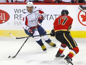 Calgary Flames Milan Lucic battles Washington Capitals Alex Ovechkin in first period NHL action at the Scotiabank Saddledome in Calgary on Tuesday, October 22, 2019.