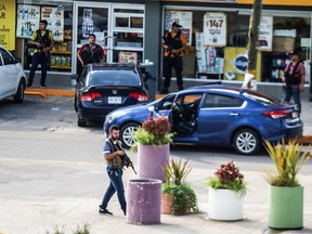 Cartel gunmen are seen during clashes with federal forces following the detention of Ovidio Guzman, son of drug kingpin Joaquin "El Chapo" Guzman, in Culiacan, Mexico October 17, 2019. (REUTERS/Jesus Bustamante)