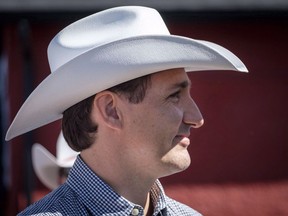 Prime Minister Justin Trudeau listens to speeches as he attends a pancake breakfast in Calgary on Saturday, July 7, 2018. Talk of western separation, or Wexit, as some have called it, is percolating a day after the federal Liberals were returned to power with a minority government.
