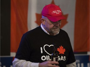 Wearing a 'Make Trudeau A Drama Teacher Again' hat and an 'I Heart Canadian Oil and Gas' t-shirt, Paul Bunner President of Edmonton Strathcona Conservative Association watches the early federal election results at the Lyon restaurant, 10335 83 Ave., in Edmonton Monday Oct. 21, 2019. The restaurant was hosting the election night event for Edmonton-Strathcona Conservative Party of Canada candidate Sam Lilly.