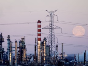 The moon sinks behind Refinery Row.