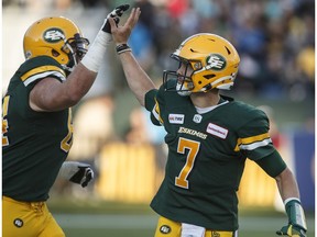 Edmonton Eskimos quarterback Trevor Harris (7) and Tommie Draheim (64) celebrate a touchdown against the Toronto Argonauts during first half CFL action in Edmonton on Thursday July 25, 2019.