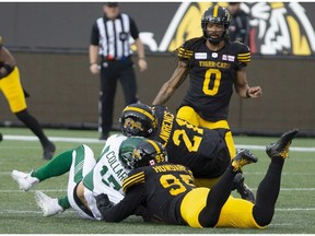 Saskatchewan Roughriders quarterback Zach Collar is hit late by Hamilton Tiger-Cats' Simoni Lawrence after Collaros was downed by Tiger-Cats' Julian Howsare during first half CFL football game action in Hamilton on Thursday, June 13, 2019.