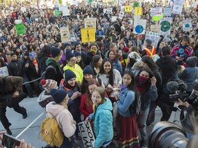 Swedish climate activist Greta Thunberg, in blue jacket,   joined about 8,000  Edmonton youth, climate activists, and community members outside the Alberta Legislature in a climate strike. on October 18, 2019. Photo by Shaughn Butts / Postmedia