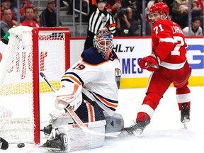 Edmonton Oilers goaltender Mikko Koskinen (19) makes a save against Detroit Red Wings center Dylan Larkin (71) in the second period at Little Caesars Arena on Oct. 29, 2021.