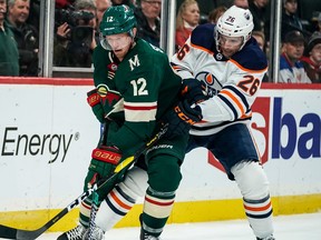 Oct 22, 2019; Saint Paul, MN, USA; Minnesota Wild forward Eric Staal  (12) protects the puck from Edmonton Oilers defenseman Brandon Manning (26) during the second period at Xcel Energy Center. Mandatory Credit: Brace Hemmelgarn-USA TODAY Sports ORG XMIT: USATSI-405132