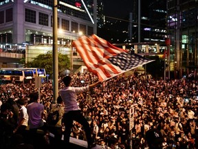 Protesters attend a rally in Hong Kong on Monday, Oct. 14, 2019, calling on U.S. politicians to pass a bill that could alter Washington's relationship with the trading hub.