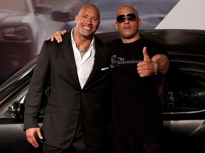 Vin Diesel, right, and Dwayne Johnson pose for photos as they arrive to attend the premiere of the film"Fast Five: in Rio de Janeiro, Brazil, Friday April 15, 2011.