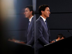 Prime Minister Justin Trudeau speaks to the news media for the first time since winning a minority government in the federal election, at the National Press Theatre in Ottawa, Oct. 23, 2019. (REUTERS/Stephane Mahe)