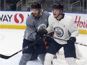 Matt Benning (83) and Colby Cave (12) take part in an Edmonton Oilers' practice at Rogers Place, in Edmonton Friday Oct. 4, 2019.