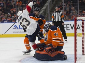 The Edmonton Oilers' goalie Mike Smith (41) makes a pad save as he battles the Florida Panthers' Evgenii Dadonov (63) during first period NHL action at Rogers Place, in Edmonton Sunday Oct. 27, 2019.