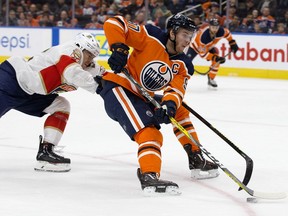 The Edmonton Oilers' Connor McDavid (97) battles the Florida Panthers' MacKenzie Weegar (52) during second period NHL action at Rogers Place, in Edmonton Sunday Oct. 27, 2019.