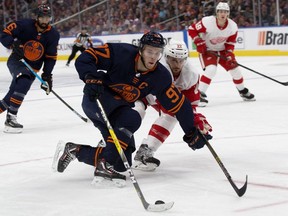 Edmonton Oilers centre Connor McDavid battles Detroit Red Wings defenceman Patrik Nemeth during NHL action on Oct. 18, 2019, at Rogers Place.