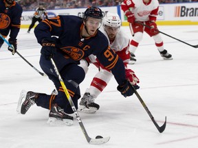The Edmonton Oilers' Connor McDavid (97) battles the Detroit Red Wings' Patrik Nemeth (22) during second period NHL action at Rogers Place in Edmonton on Friday, Oct. 18, 2019.