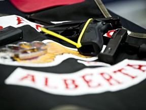 Police show off items confiscated during 10 search warrant that were executed at Alberta Hells Angels clubhouses on Wednesday morning at K Division headquarters in Edmonton, Alta., on Friday, April 25, 2014. Codie McLachlan/Edmonton Sun/QMI Agency