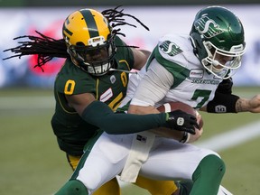 The Edmonton Eskimos' Don Unamba (0) battles the Saskatchewan Roughriders' quarterback Cody Fajardo (7) during first half CFL action at Commonwealth Stadium in Edmonton Saturday Oct. 26, 2019. Fajardo (7) fumbled the ball on the play. Photo by David Bloom