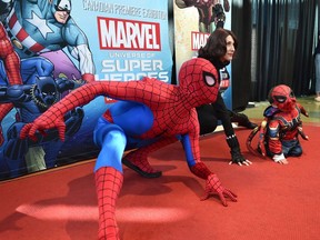 Elliot Sloat, 3, posing with Spiderman and Black Widow at the TELUS World of Science which heralded in the opening weekend of the Canadian Premiere of Marvel: Universe of Super Heroes in Edmonton, October 17, 2019.