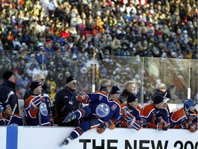 Wayne Gretzky leaps off the bench to join the play during the Heritage Classic hockey game at Commonwealth Stadium on Nov. 22, 2003.