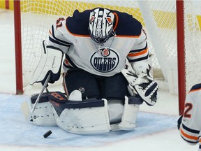 Edmonton Oilers goaltender Mike Smith tries to control a rebound during NHL action against the Jets in Winnipeg on Sun., Oct. 20, 2019.