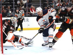 ANAHEIM, CALIFORNIA - NOVEMBER 10:  John Gibson #36 and Cam Fowler #4 of the Anaheim Ducks are unable to stop a goal scored by Zack Kassian #44 of the Edmonton Oilers during the second period of a game at Honda Center on November 10, 2019 in Anaheim, California.