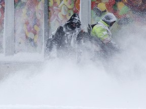 Crews clear snow near 80 Avenue and 104 Street, in Edmonton Friday March 8, 2019. Environment Canada issued a snowfall warning for the city of Edmonton Friday as forecasters warned of snowfall amounts of 10 to 20 cm. Photo by David Bloom