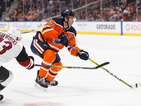 Edmonton Oilers' Connor McDavid (97) is chased by Arizona Coyotes' Alex Goligoski (33) during the second period of a NHL hockey game at Rogers Place in Edmonton, on Monday, Nov. 4, 2019. Photo by Ian Kucerak/Postmedia