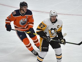 Edmonton Oilers Connor McDavid (97) and Pittsburgh Penguins Sidney Crosby (87) in action during NHL action at Rogers Place in Edmonton, October 23, 2018.