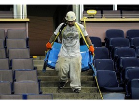 A worker (Eric Navarro) removes seats at the former Northlands Coliseum on Thursday May 30, 2019.
