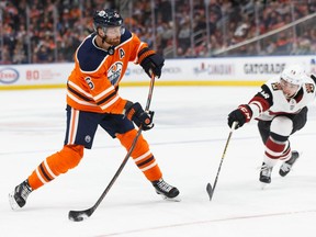 Edmonton Oilers' Adam Larsson (6) shoots past Arizona Coyotes' Michael Bunting (58) during the second period of a NHL preseason game at Rogers Place in Edmonton, on Tuesday, Sept. 24, 2019. Photo by Ian Kucerak/Postmedia