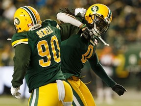 Edmonton Eskimos' Almondo Sewell (90) and Don Unamba (0), celebrate a sack during second half CFL action versus the BC Lions at Commonwealth Stadium in Edmonton, on Saturday, Oct. 12, 2019. Photo by Ian Kucerak/Postmedia