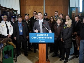 Alberta Justice Minister Doug Schweitzer, at podium, announces the government’s initial plan to combat rural crime in Alberta on Wednesday, Nov. 6, 2019, at a private ranch in Wetaskiwin County.