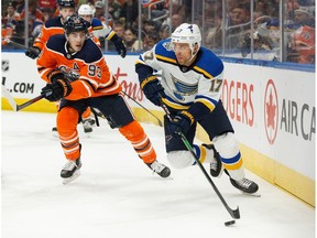 Edmonton Oilers' Ryan Nugent-Hopkins (93) battles St. Louis Blues' Jaden Schwartz (17) during the first period of a NHL hockey game at Rogers Place in Edmonton, on Wednesday, Nov. 6, 2019.