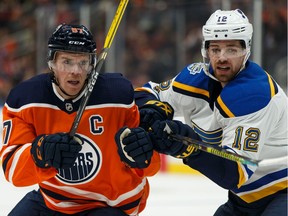 Edmonton Oilers' Connor McDavid (97) battles St. Louis Blues' Zach Sanford (12) during the second period of a NHL hockey game at Rogers Place in Edmonton, on Wednesday, Nov. 6, 2019.