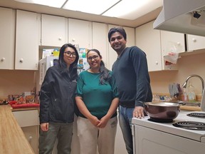 (Left to right) Empower Me program coordinator Jaclyn Cai, Edmonton newcomer Rajvi Makwana and Empower Me energy mentor Brijal Patel pose in Makwana's south Edmonton kitchen. Empower Me is an Alberta company that teaches people new to Canada about energy efficiency. Jason Herring photo