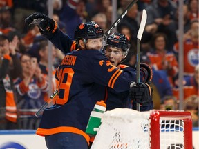 Edmonton Oilers' Alex Chiasson (39) celebrates a goal on New Jersey Devils' goaltender Cory Schneider (35) during the third period of a NHL hockey game at Rogers Place in Edmonton, on Friday, Nov. 8, 2019.