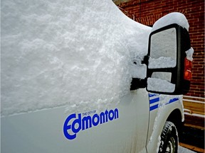 A City of Edmonton truck is covered in snow on Nov. 10, 2019. A seasonal parking ban following the weekend snowstorm was lifted Wednesday afternoon.