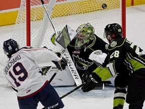 Tri-City Americans Connor Bouchard eludes a check by Edmonton Oil Kings Aidan Lawson and scores on Oil Kings goalie Sebastian Cossa during first period WHL hockey game action in Edmonton on Monday November 11, 2019.