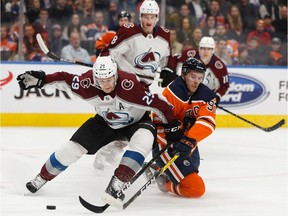 Edmonton Oilers' Connor McDavid (97) battles Colorado Avalanche's Nathan MacKinnon (29) during a NHL hockey game at Rogers Place in Edmonton, on Thursday, Nov. 14, 2019.