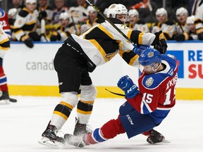 Edmonton Oil Kings' Scott Atkinson (15) is knocked down by Brandon Wheat Kings' Duncan Pierce (21) during the first period of a WHL hockey game at Rogers Place in Edmonton, on Sunday, Nov. 17, 2019. Photo by Ian Kucerak/Postmedia