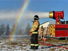 A rainbow appears during a fire demonstration at the Leduc County Fire Services training facility of the Drago Pumper Truck equipped with the latest version of the Advanced Fire Suppression Cannon, a complete fire apparatus which sits on top of the truck, in Leduc, November 21, 2019. Ed Kaiser/Postmedia