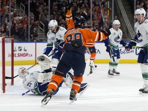 The Edmonton Oilers' Sam Gagner (89) celebrates Connor McDavid's (97) goal against the Vancouver Canucks during first period NHL action, in Edmonton Saturday Nov. 30, 2019.
