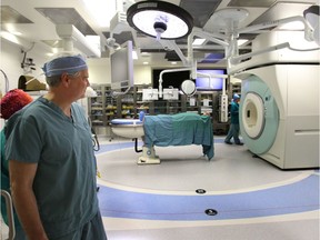 Dr. Keith Aronyk, clinical department head for neurosciences, watches as an MRI unit is moved into place at University Hospital on Feb 21, 2013.