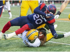 Montreal Alouettes linebacker Boseko Lokombo (20) tackles Edmonton Eskimos running back C.J. Gable (2) during 3rd quarter CFL East Semifinal football action Sunday, November 10, 2019 in Montreal.