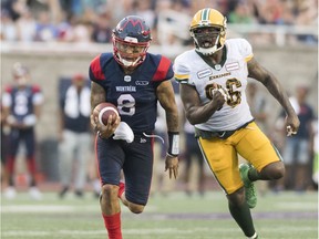 Montreal Alouettes quarterback Vernon Adams Jr. (8) breaks away from Edmonton Eskimos' Larry Dean (11) and Mike Moore during second half CFL football action in Montreal, Saturday, July 20, 2019.
