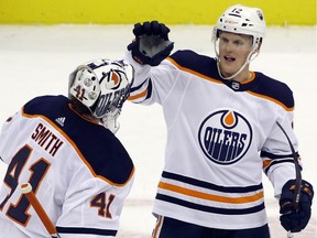 Edmonton Oilers goaltender Mike Smith (41) and center Colby Cave (12) celebrate after defeating the Pittsburgh Penguins at PPG PAINTS Arena. The Oilers won 2-1 in overtime.