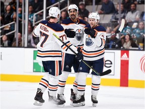 Edmonton Oilers winger Jujhar Khaira, middle, celebrates with defencemen Oscar Klefbom, left, and Kris Russell after scoring a goal against the host San Jose Sharks on Nov. 19, 2019.