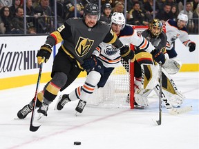 Vegas Golden Knights left wing William Carrier (28) skates the puck away from Edmonton Oilers center Gaetan Haas (91) during the second period at T-Mobile Arena.