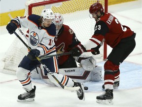 CP-Web.  Edmonton Oilers left wing Joakim Nygard (10) tries to redirect the puck as Arizona Coyotes defenseman Oliver Ekman-Larsson (23) and Coyotes goaltender Darcy Kuemper, center, protect the net during the first period of an NHL hockey game Sunday, Nov. 24, 2019, in Glendale, Ariz.